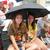 Lauren Debes and Jennifer Terrell sharing an umbrella waiting for the Parade.